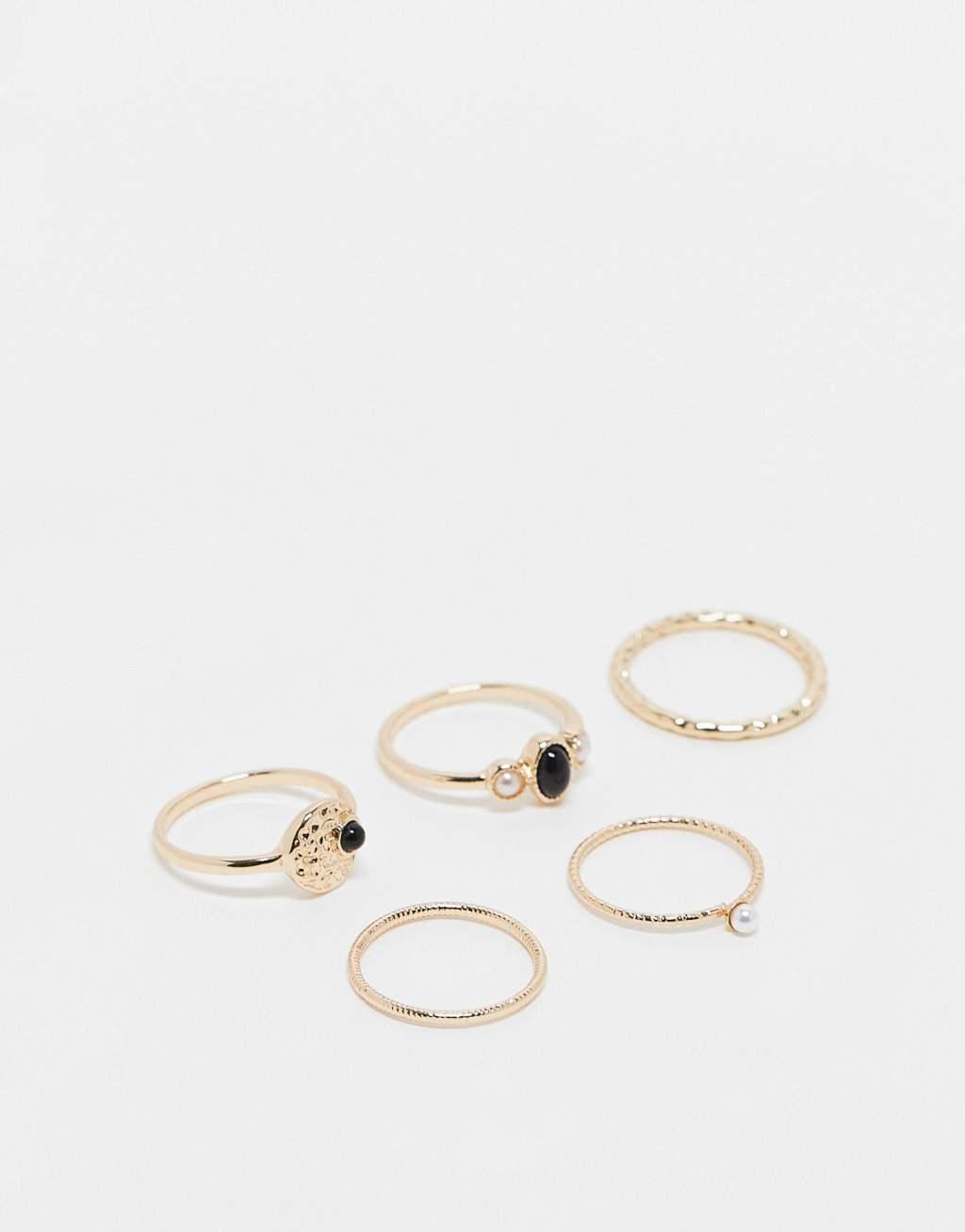 ASOS DESIGN 5-pack rings with black stone and faux pearl design in gold tone Product Image