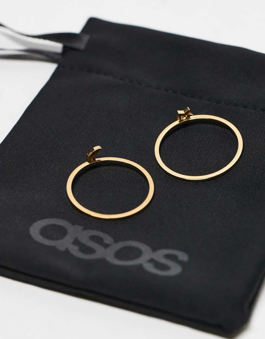 ASOS DESIGN waterproof stainless steel pack of 2 rings with star and moon in gold tone with gift bag Product Image