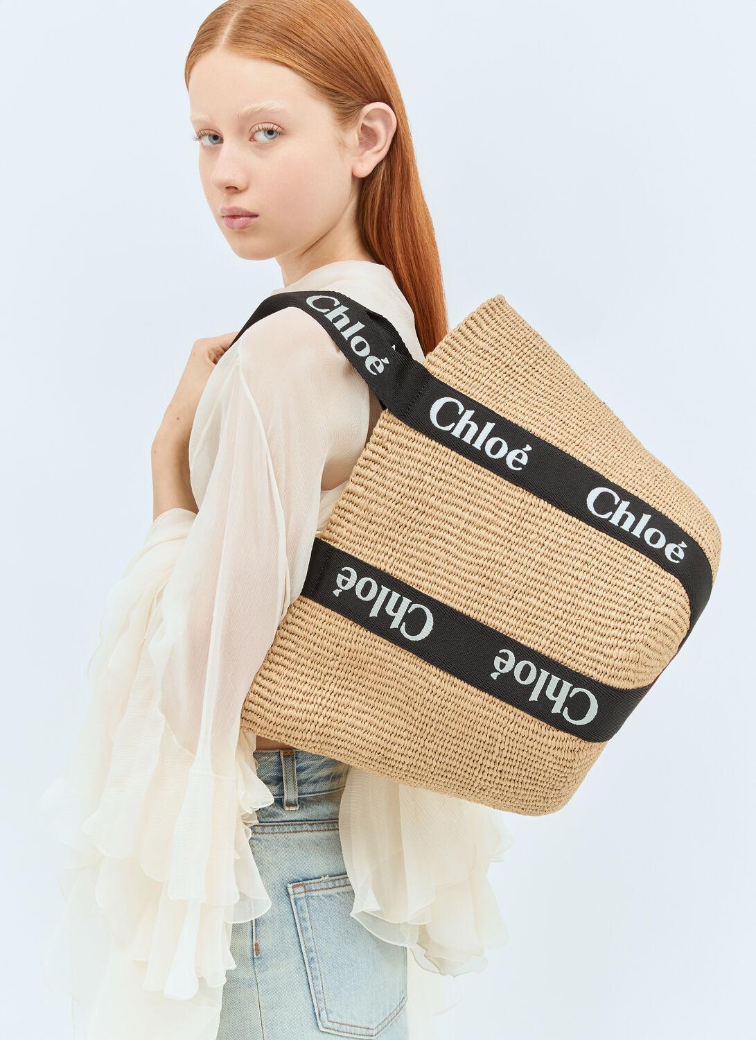 Woody Logo Embroidered Top-handle Bag In Beige Product Image