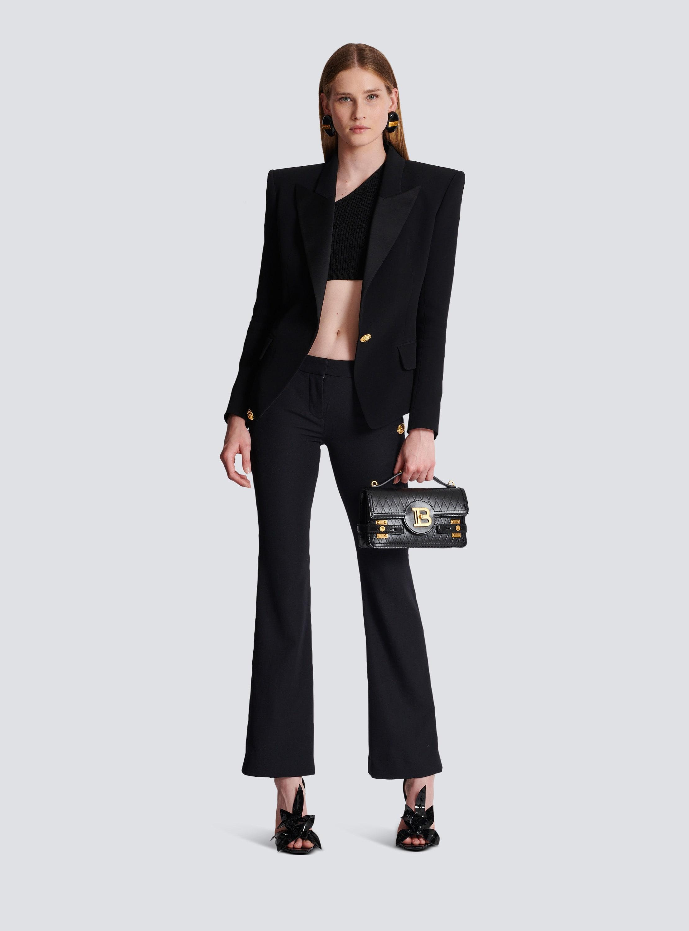 Flared trousers with buttons Product Image