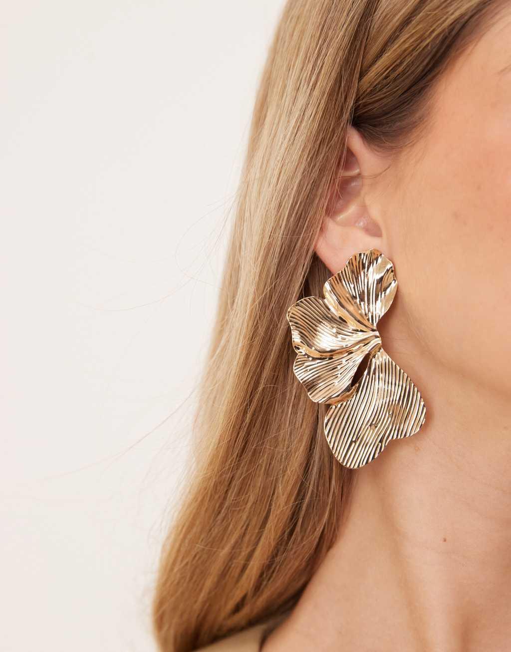 ASOS DESIGN stud earrings with oversized floral petal detail in gold tone Product Image