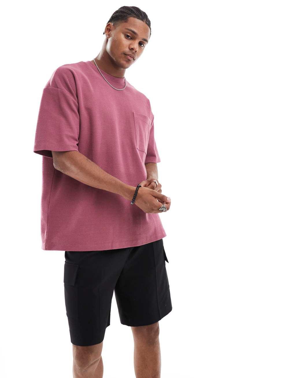 ASOS DESIGN oversized textured t-shirt with front pocket in pink Product Image