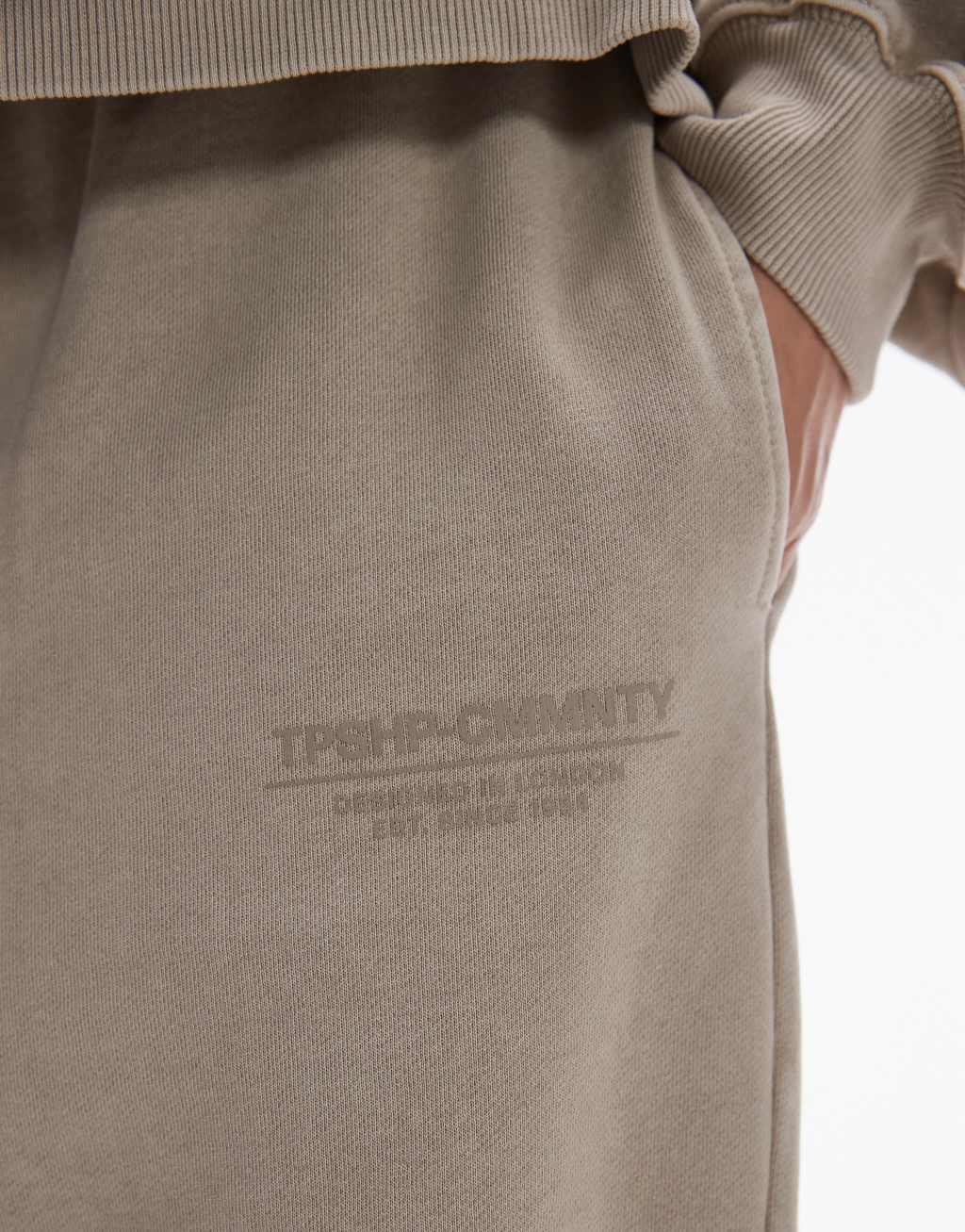 Topshop Community graphic cuffed sweatpants in stone Product Image