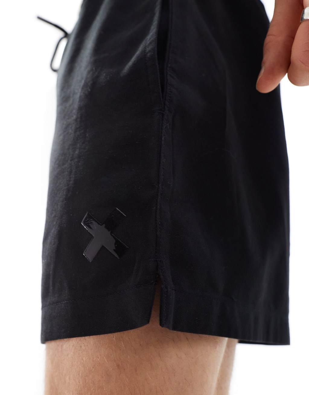 COLLUSION shorter length swim shorts in black Product Image