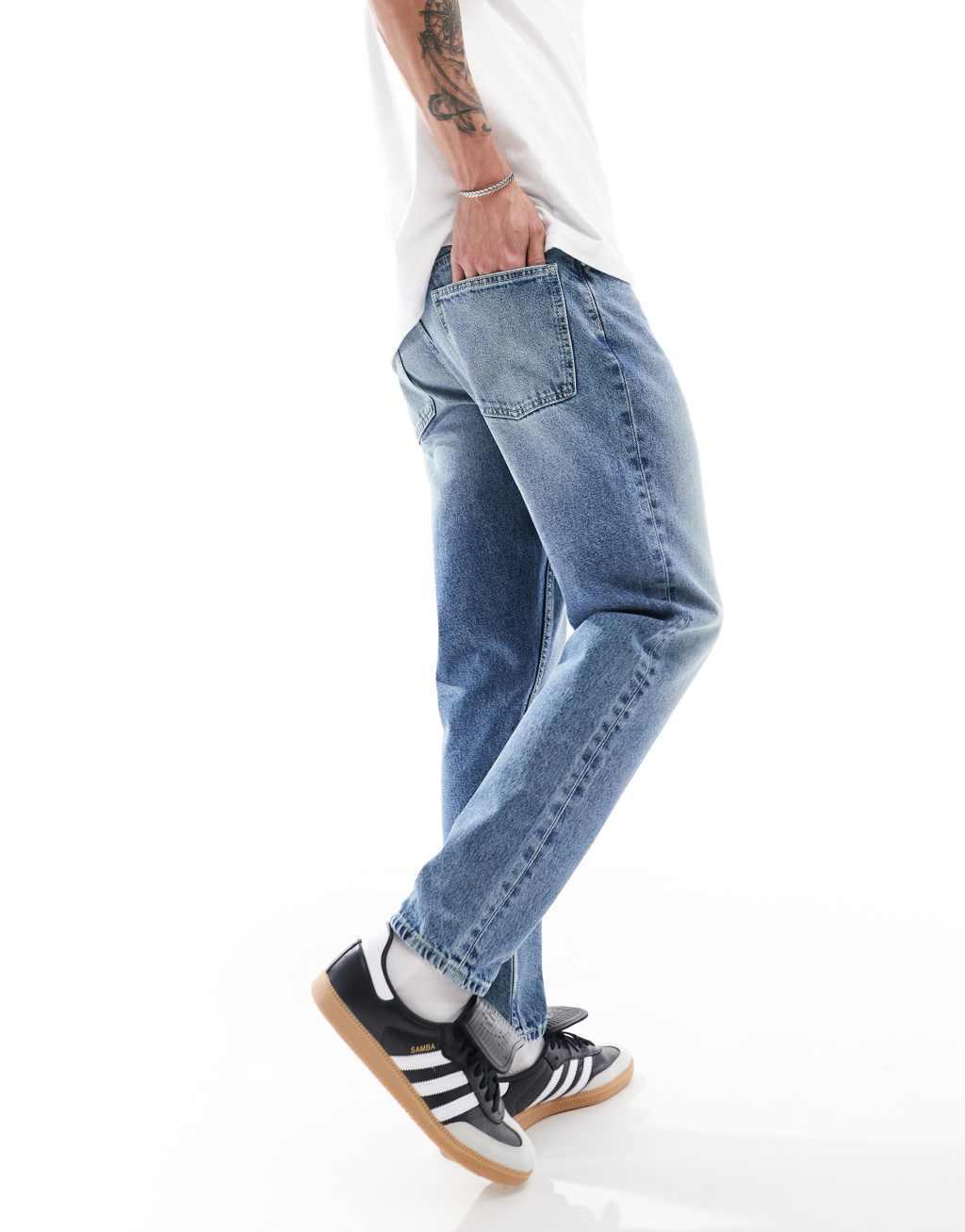 ASOS DESIGN tapered fit jeans in mid wash blue  Product Image