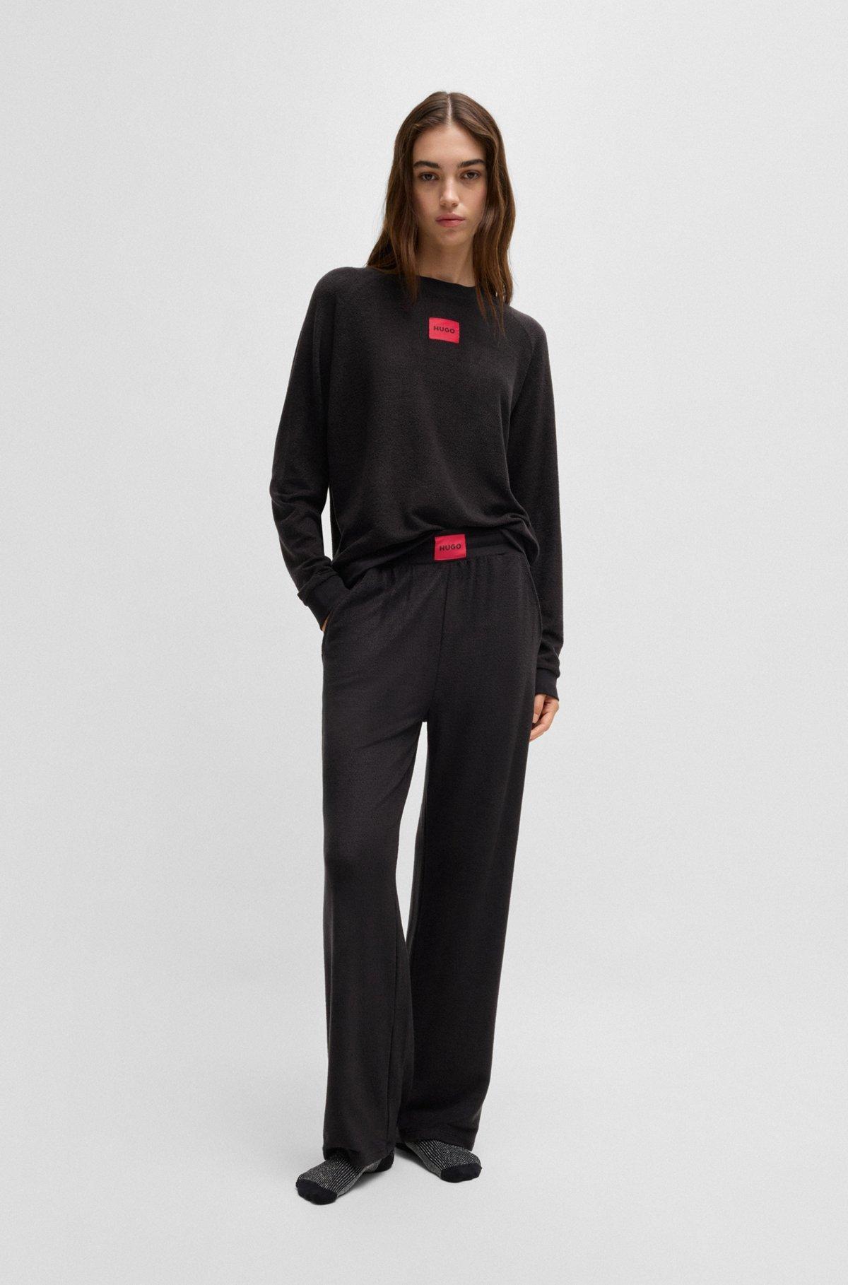 Terry tracksuit bottoms with red logo label Product Image