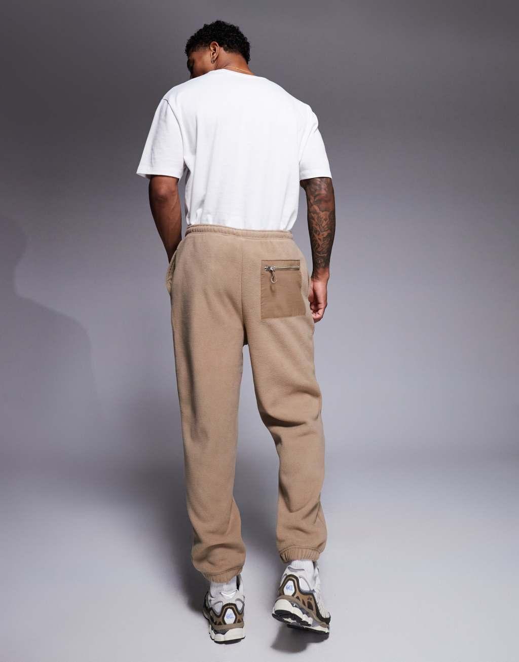 ASOS DESIGN tapered fleece sweatpants in brown Product Image