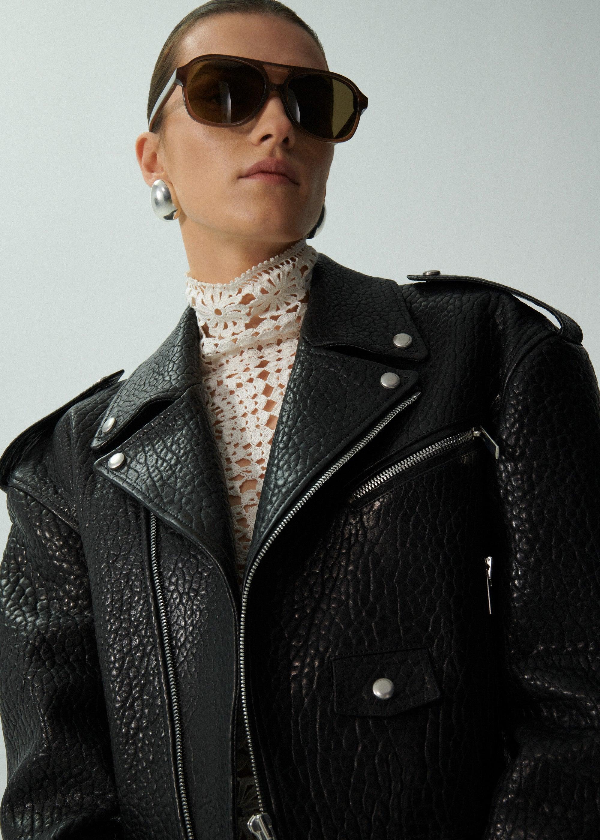 Cropped leather biker jacket in embossed black Product Image