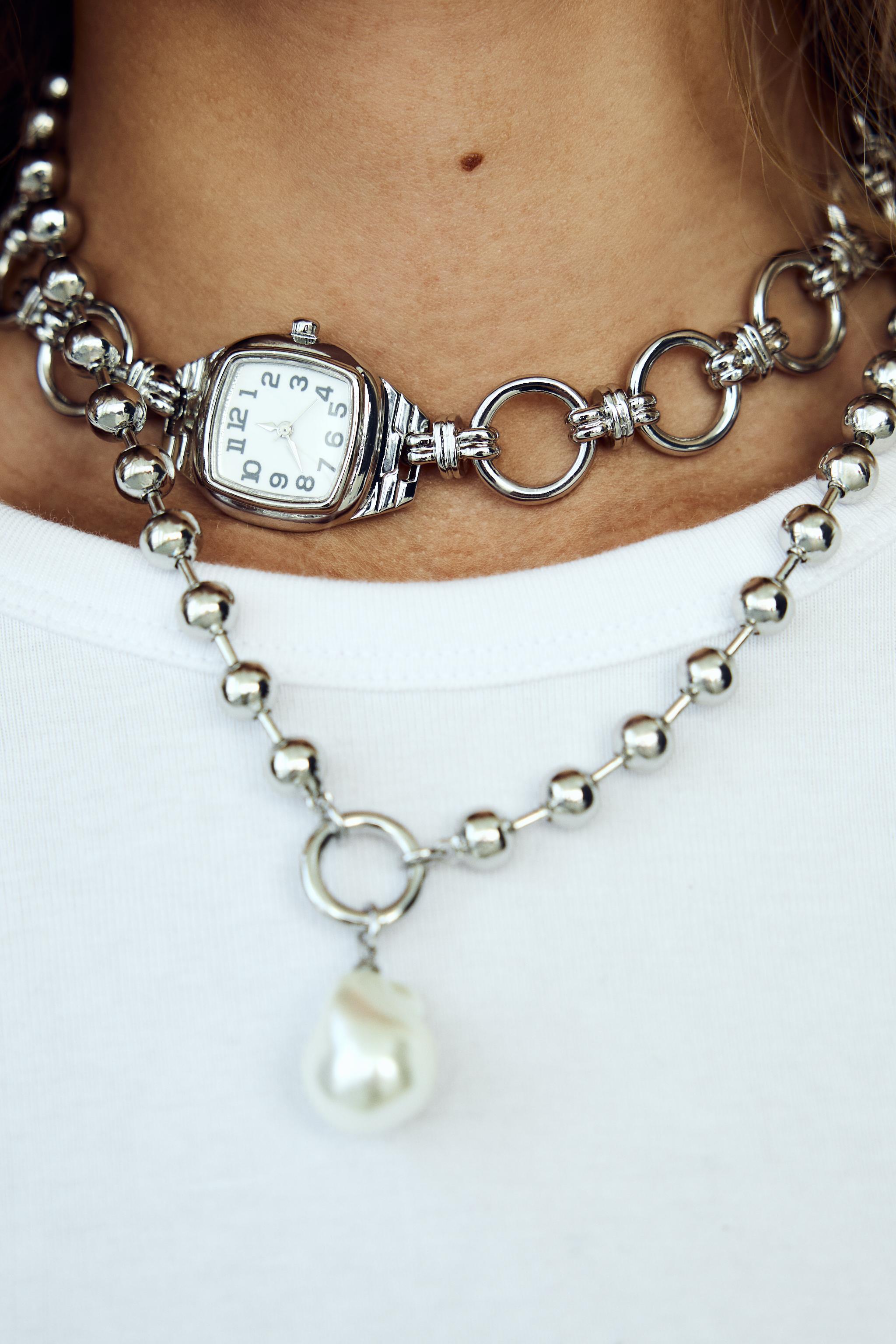 PACK OF 2 CLOCK AND FAUX PEARL NECKLACES Product Image