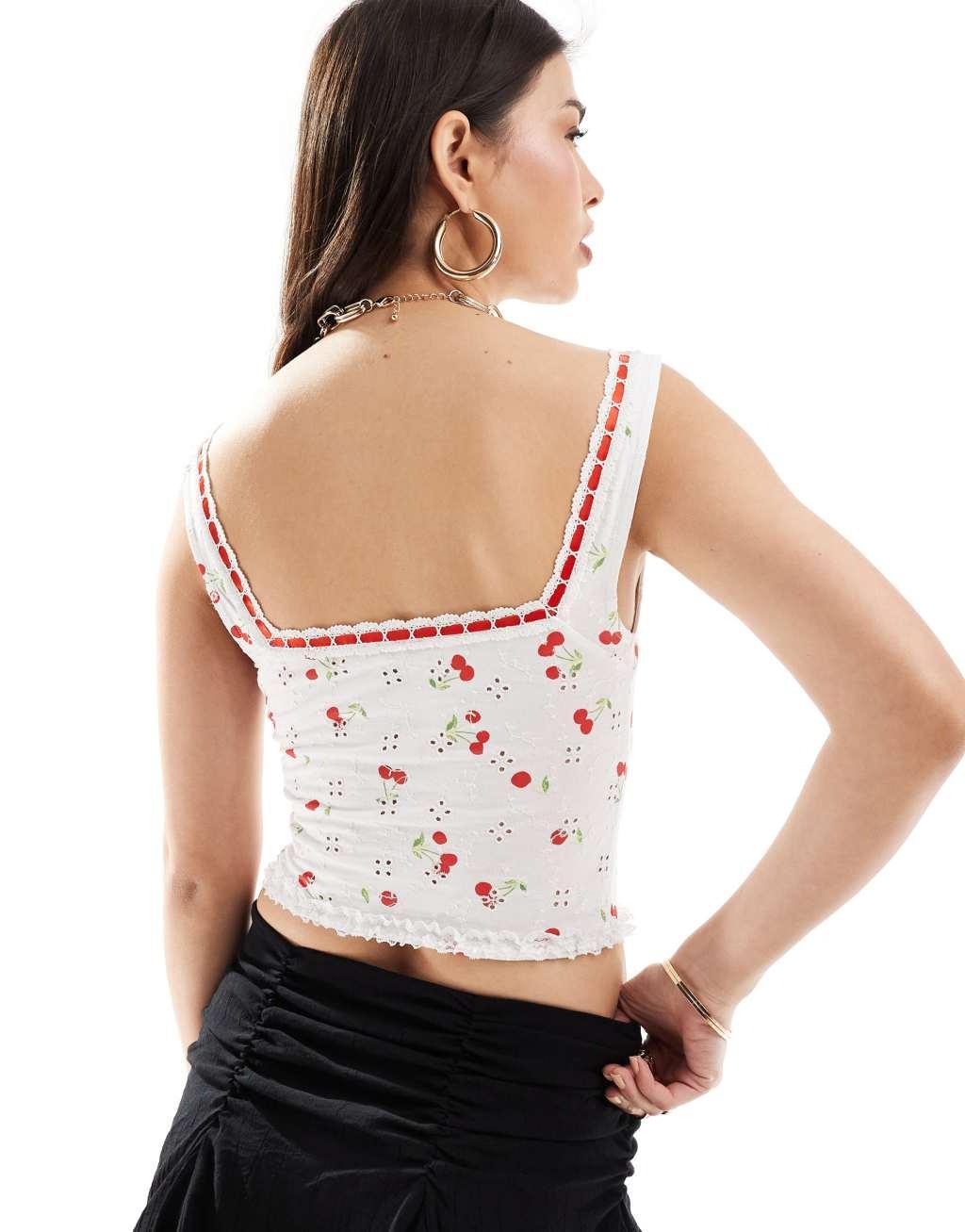 ASOS DESIGN eyelet bust cup corset tank top with contrast lace up detail in cherry print Product Image