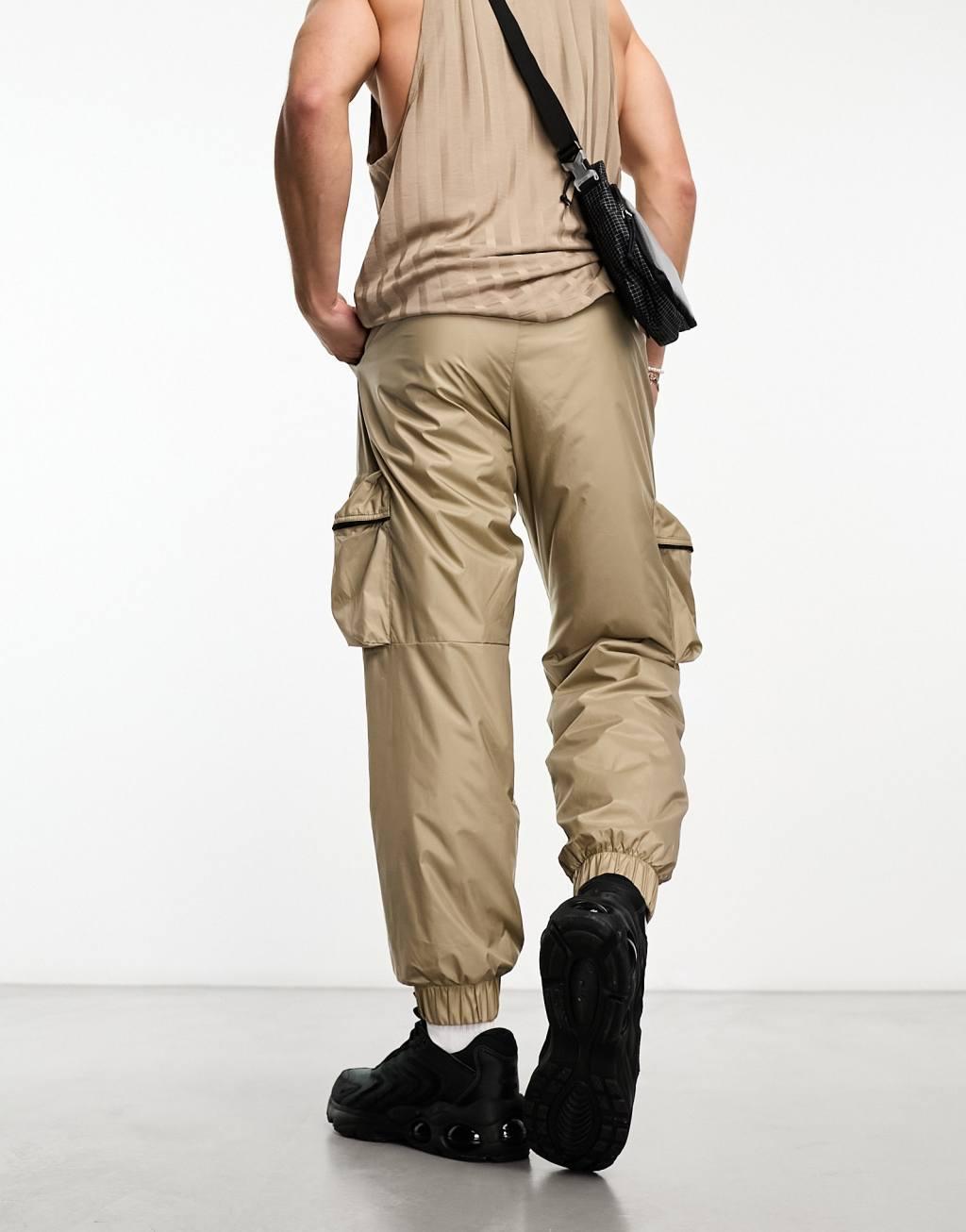 Nike Tech Essentials wind sweatpants in brown Product Image