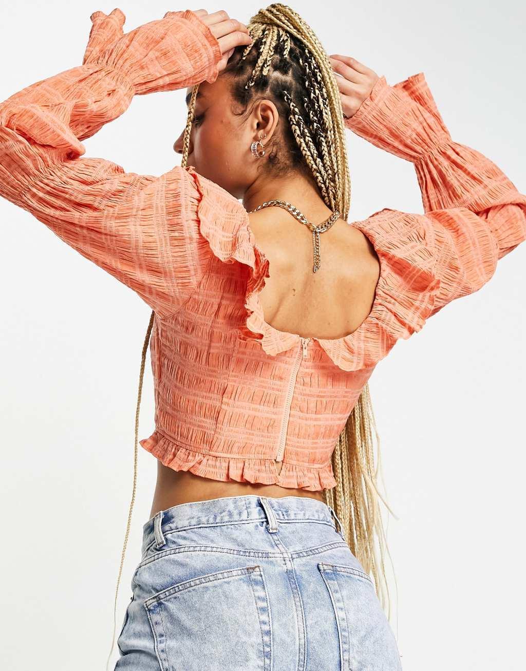 ASOS DESIGN shirred crop top with ruffle detail and volume sleeve in rust Product Image