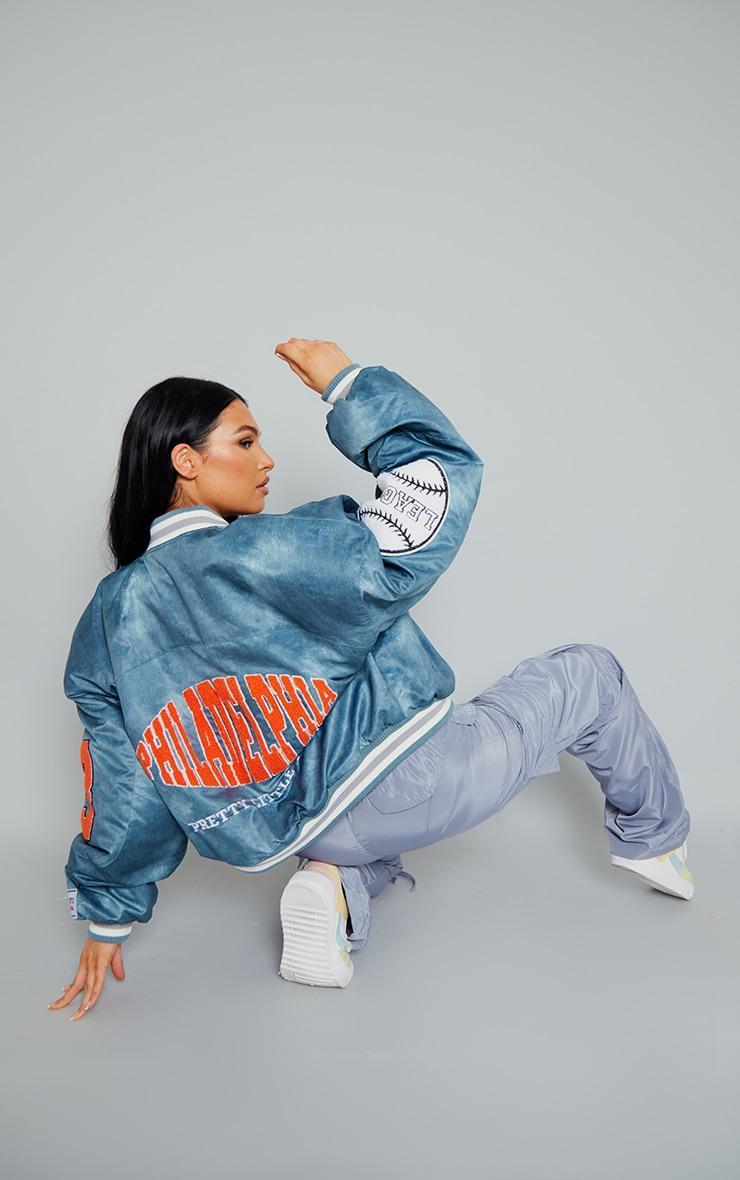 PRETTYLITTLETHING Blue Graphic Back Brushed Look Satin Bomber Jacket Product Image